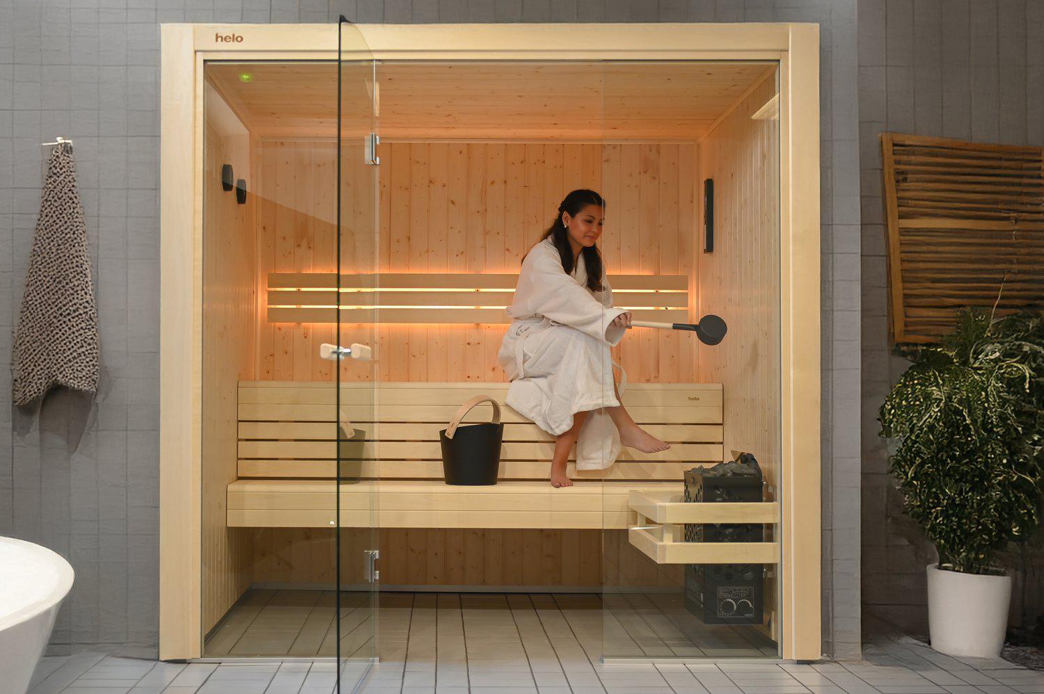 Spacious Hanko  sauna interior with smooth aspen benches and soft ambient LED lighting
