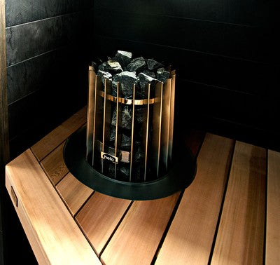 The Helo Rocher 105 Elite Sauna Heater features a sculptural round design with 100 kg stone capacity for soft, drop-like steam. Includes Elite controller. 